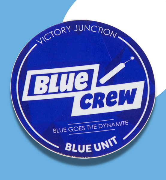 A round blue sticker that reads "Victory Junction" at the top. In the middle reads, "Blue Crew. Blue goes the dynamite." At the bottom reads  "Blue Unit."